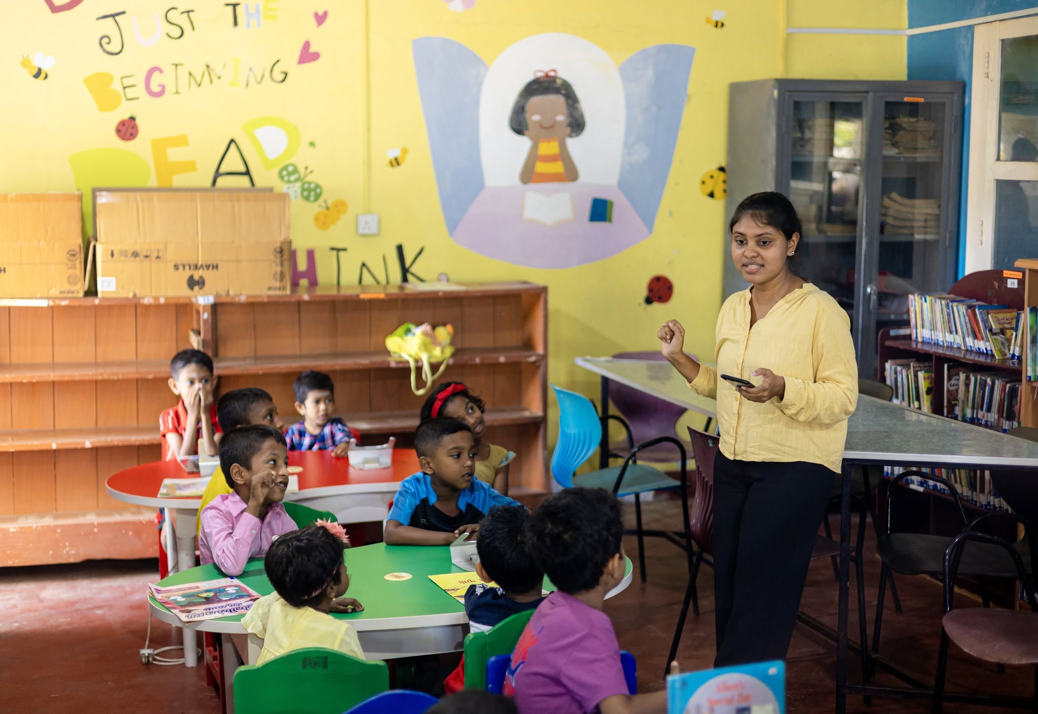 Teacher and children learning English with flashcards